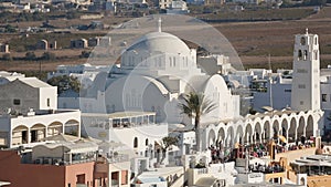 Crowd of tourists viewing Orthodox Metropolitan Church in Santorini island