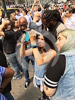 A crowd views the solar eclipse at a park in New York City