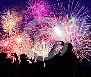 Crowd Watching and Recording Fireworks on Cellphones