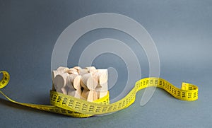 A crowd of wooden figures Gripped by measuring tape. Social Sciences. Promotion of ideas for weight loss, lifestyle. Information