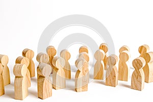 A crowd of wooden figures of people on a white background. Social survey and public opinion, the electorate. Population