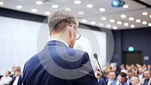 Crowded auditorium hall listen public speech of man employee speaking business