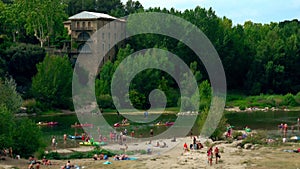 Crowded beach on the River Gardon close to Pont du Gard aqueduct, France