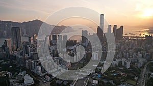 Crowded city and harbor view during sunset in Hong Kong