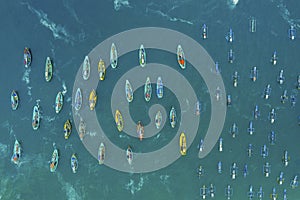 Crowded fishing boats sailing on Papuma beach