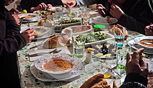 Crowded muslim family having iftar together in happiness with delicious food