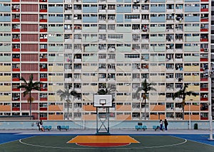 Crowded narrow apartments in the building of Choi Hung public housing estate in Kowloon, Hong Kong, with a basketball stand in the