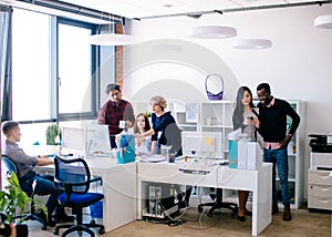 Crowded office with young active employees photo