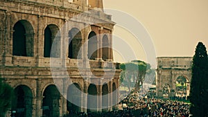 Crowded square near famous Colosseum or Coliseum amphitheatre in Rome, Italy
