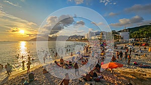 Crowds of beachgoers waiting for the sunset overlooking Ipanema and Leblon beach from Arpoador