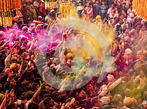 Crowds can be seen below duirng Holi Festival in India, throwing powdered paint