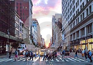 Crowds of diverse people cross the busy intersection on 23rd Street and 5th Avenue in Manhattan New York City