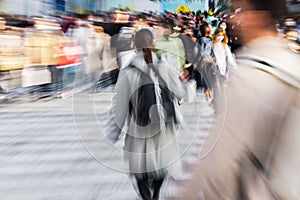 crowds of people crossing the Shibuya crossing in Tokyo, Japan