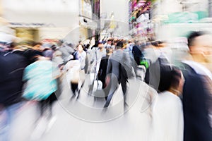 crowds of people crossing the Shibuya crossing in Tokyo, Japan