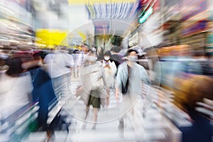 crowds of people crossing the Shibuya crossing in Tokyo, Japan