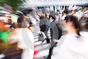 crowds of people crossing the Shibuya crossing in Tokyo, Japan