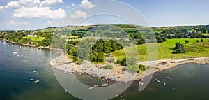 Crowds of people on a small lakeside beach in the middle of summer (Ullswater, Lake District, England