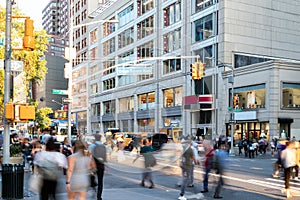 Crowds of people walking across the busy intersection on 14th Street at Union Square Park in New York City