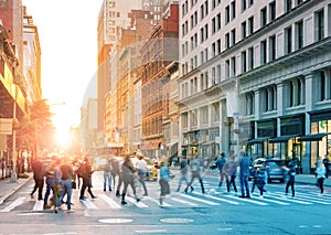 Crowds of people walking across the busy intersection in Midtown Manhattan, New York City