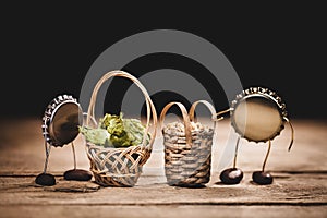 Crown cork miniature figures with hop cones and malted barley, brewing beer ingredients