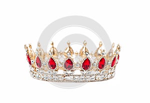 Crown with red gemstones isolated on white background