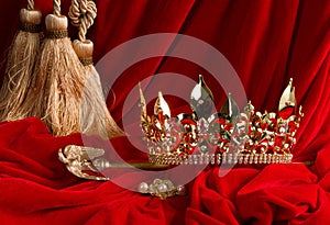 Crown and scepter on red velvet