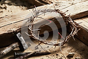 Crown of thorns among cross, hammer with nails photo