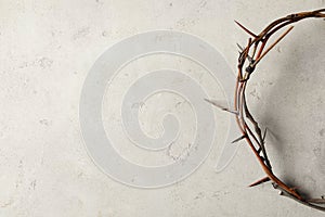 Crown of thorns on light background, top view with space for text. Easter attribute