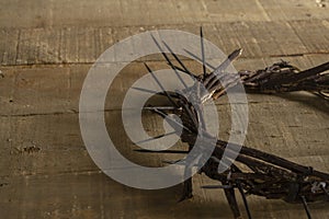 Crown of thorns on wooden background with copy space. Easter religious motive commemorating the resurrection of Jesus photo