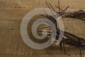 Crown of thorns on wooden background. Easter religious motive commemorating the resurrection of Jesus- Easter