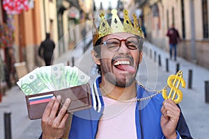 Crowned young guy with full wallet