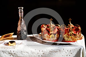 Crowns for sacrament of wedding on table in Church