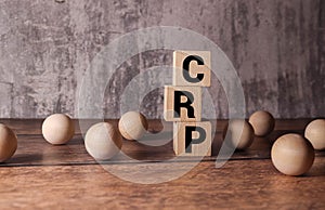 CRP - C-Reactive Protein Test symbol. Wooden cubes with word CRP. Beautiful grey background.