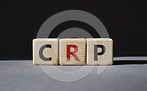 CRP - C-Reactive Protein Test symbol. Wooden cubes with word CRP. Beautiful grey background. Medical and C-Reactive Protein Test