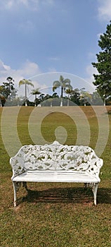 White Iron bench, Grass texture blue sky