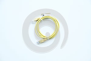 Yellow rolled-up patch cable, used to connect a computer to an internal or external network, internet connection,