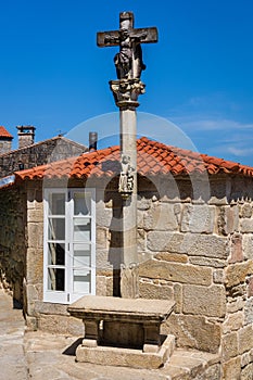Cruceiro, stone cross on a city street. Combarro, Galicia, Spain photo