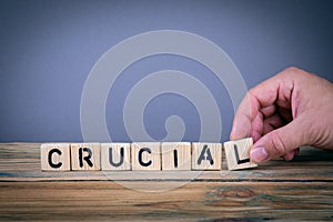 Crucial, wooden letters on the office desk