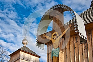 Crucified Christ on the cross in front of church in Korejovce during autumn