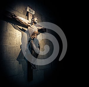 Crucifix in church on the stone wall.