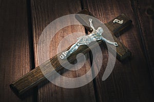 Crucifix close up on wooden background