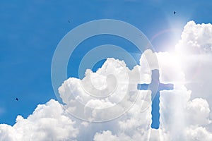 Crucifix cross on beautiful sky with sunbeam. Holy cross of Jesus christ on clouds background