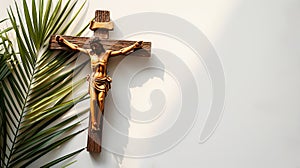 Crucifix with figure of Jesus, red candle and palm leaves on white background