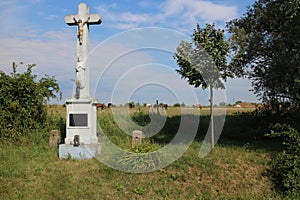 Crucifix in hayfield with horses near Devinska Nova Ves