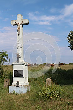 Crucifix in hayfield with horses near Devinska Nova Ves