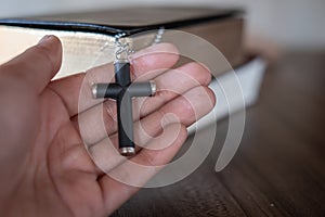 The crucifix lay on the palm of the hand,Bible background And close-up images of praying for the blessing of Jesus, God. Faith in