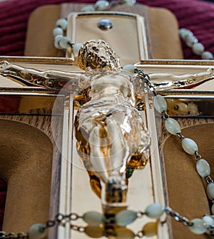 Crucifix and rosary beads of Catholic religion closeup