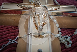 Crucifix and rosary beads of Catholic religion closeup in selective focus