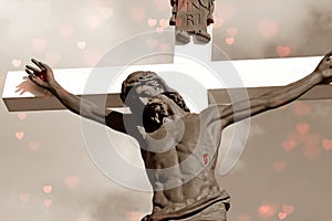 Crucifix in sepia colors with red hearts and wounds on Christ