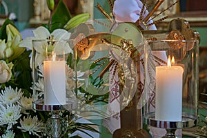 crucifixion of Christ and candles,a gilded cross in the church with the crucifixion of Jesus and two burning candles, Symbol of